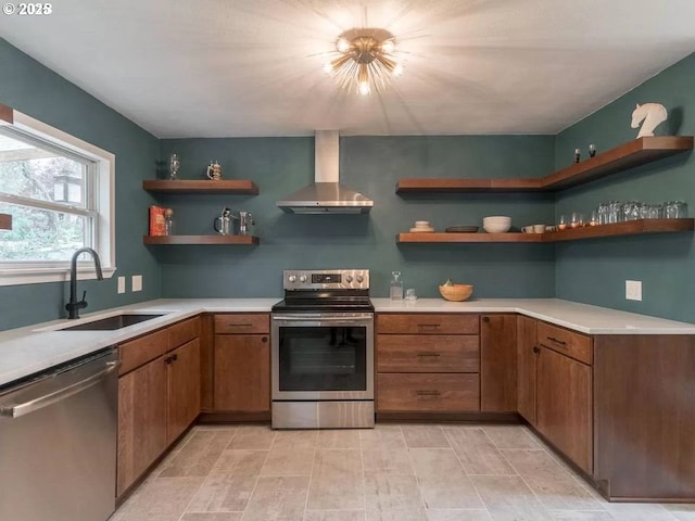 kitchen featuring wall chimney exhaust hood, stainless steel appliances, and sink