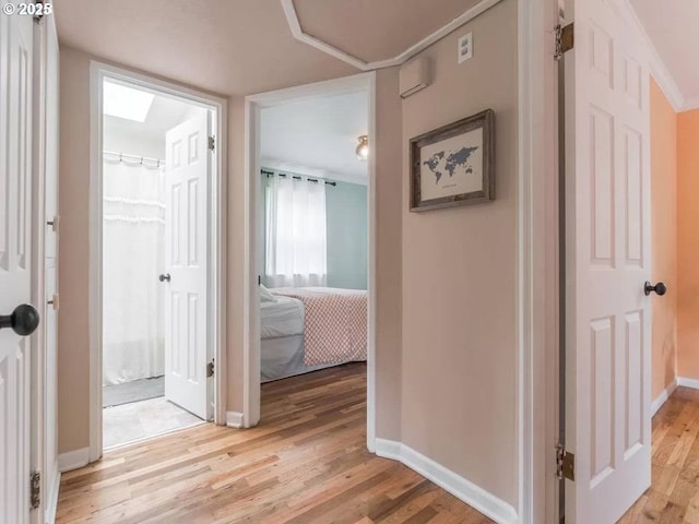 hallway with light hardwood / wood-style floors