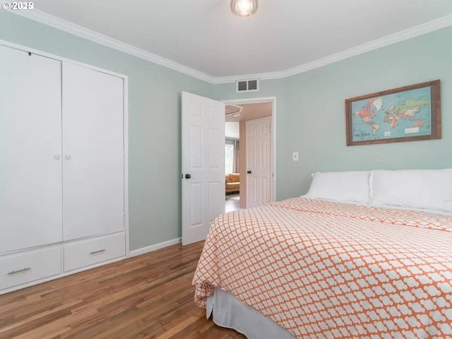 bedroom with hardwood / wood-style flooring and crown molding