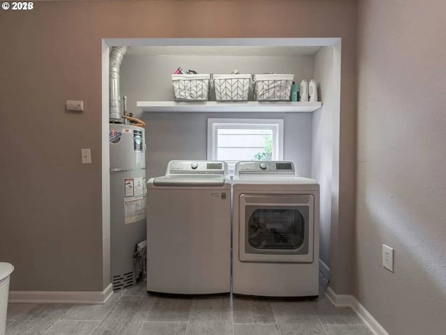 clothes washing area with independent washer and dryer and water heater