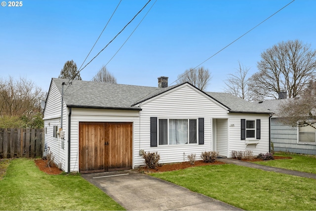 ranch-style home featuring a garage and a front lawn