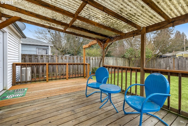 wooden deck featuring a yard, cooling unit, and a pergola