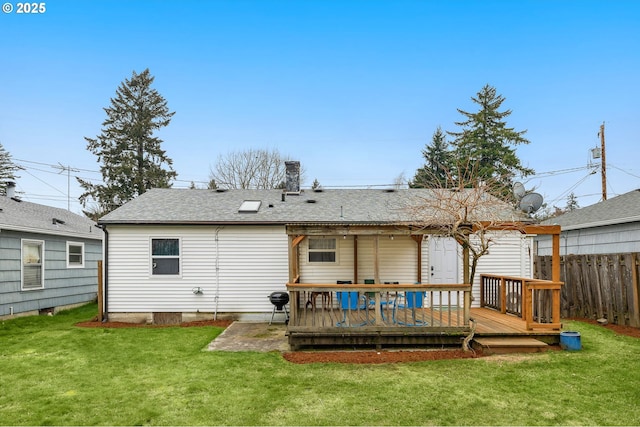 back of house featuring a yard and a deck