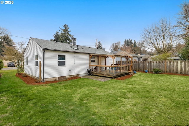 rear view of property featuring a wooden deck and a yard