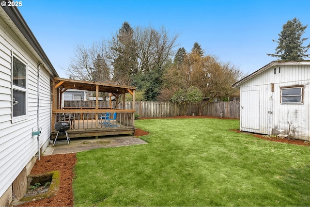 view of yard with a wooden deck and a shed