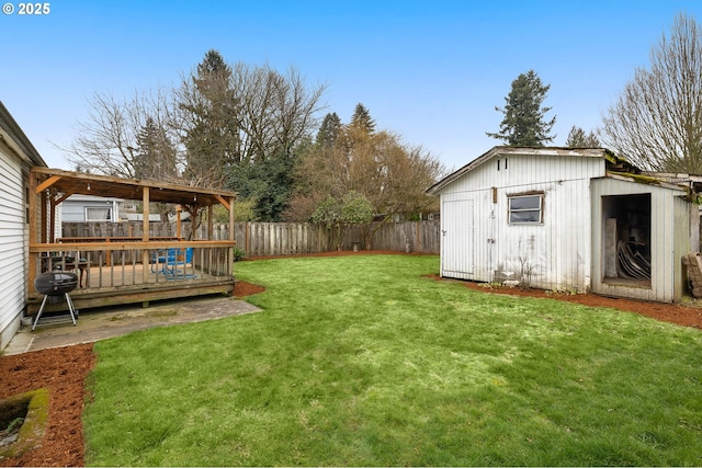 view of yard with a deck and a storage shed