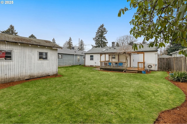 rear view of property with ac unit, a lawn, and a deck