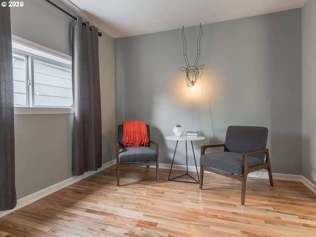 sitting room featuring light hardwood / wood-style flooring