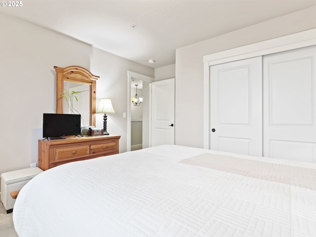 bedroom featuring a chandelier and a closet