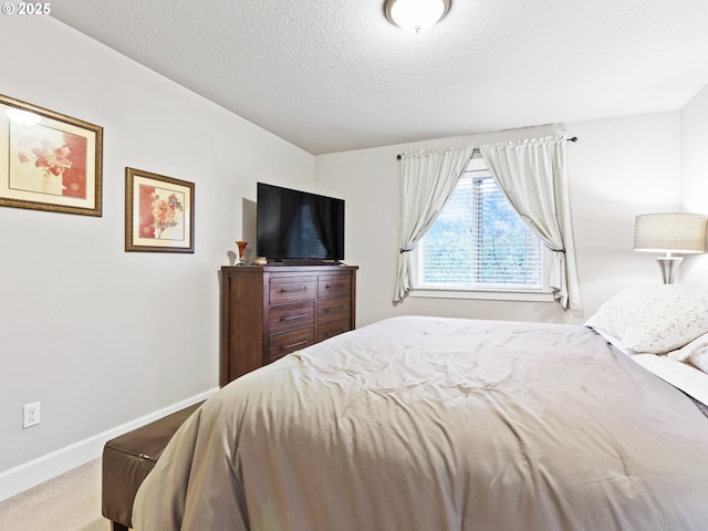 carpeted bedroom with a textured ceiling