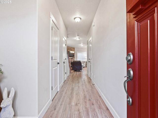 corridor with light wood-type flooring