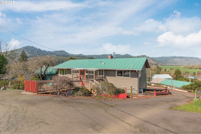 34635 Parkway Dr, Cloverdale, OR 97112 - rustic home featuring a chimney, a mountain view, metal roof, and a porch