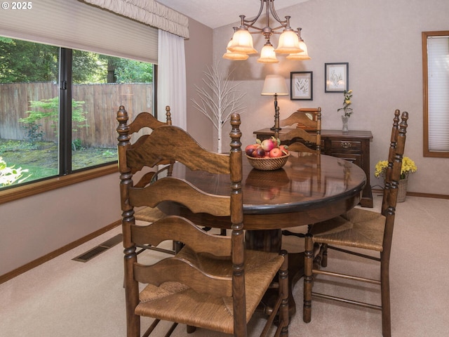 140 NE Greenway Dr, Gresham, OR 97030 - carpeted dining area with a chandelier and baseboards