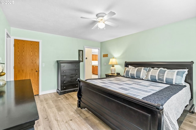 bedroom with baseboards, connected bathroom, light wood-style flooring, and ceiling fan