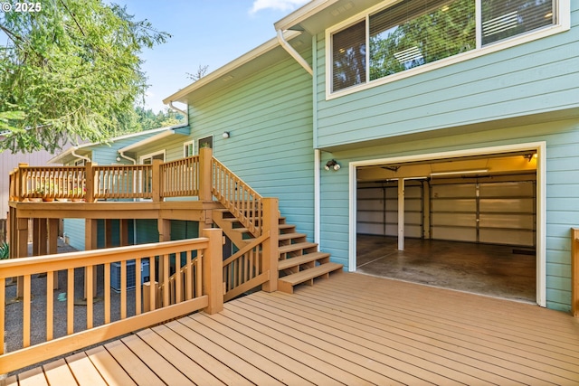 wooden deck featuring stairs and an attached garage