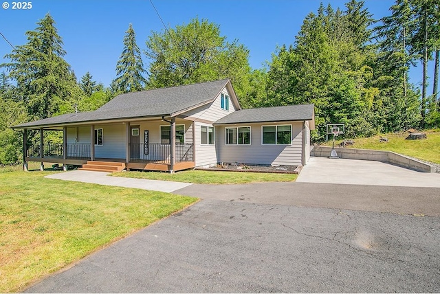 view of front of home with aphalt driveway, a porch, and a front lawn