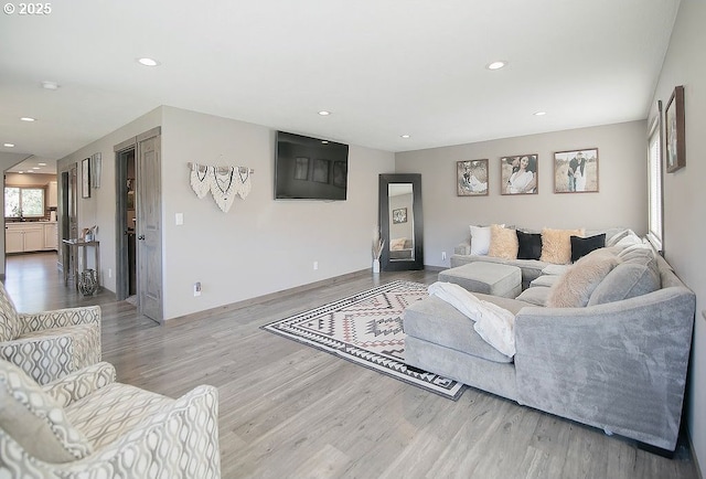 living area featuring recessed lighting, baseboards, and wood finished floors