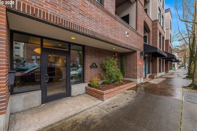 entrance to property with brick siding