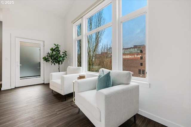 sitting room with dark wood-type flooring and baseboards