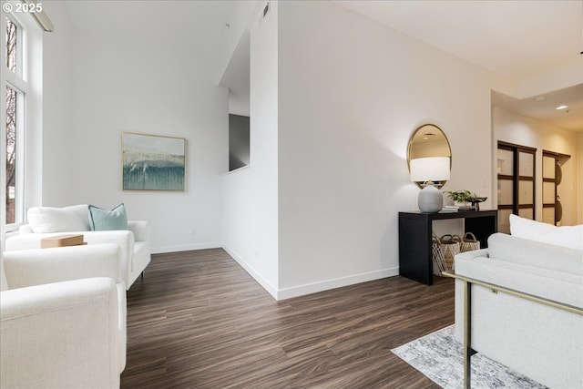 living area with dark wood finished floors and baseboards