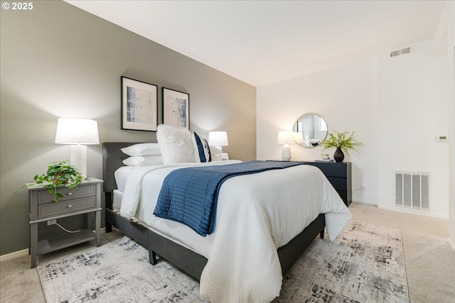 carpeted bedroom featuring baseboards and visible vents