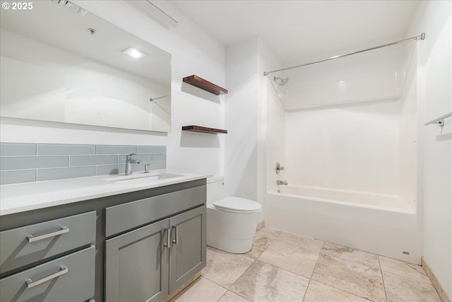 bathroom featuring tasteful backsplash, vanity, toilet, and bathing tub / shower combination