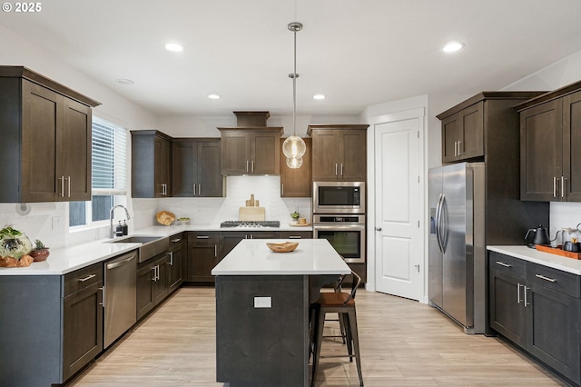 301 W 17th St, Lafayette, OR 97127 - kitchen featuring appliances with stainless steel finishes, a sink, dark brown cabinets, a breakfast bar area, and recessed lighting