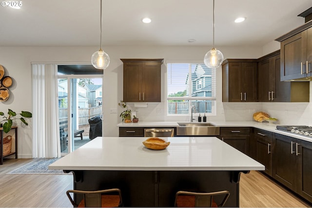 301 W 17th St, Lafayette, OR 97127 - kitchen with healthy amount of natural light, a breakfast bar area, dark brown cabinets, light wood-type flooring, and recessed lighting