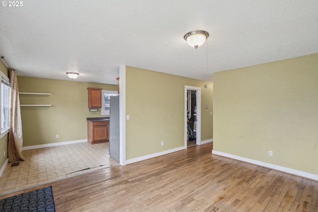 unfurnished living room with light hardwood / wood-style floors and a wealth of natural light