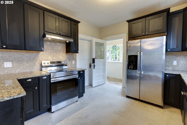 8113 SE Morrison St, Portland, OR 97215 - kitchen with appliances with stainless steel finishes, under cabinet range hood, tasteful backsplash, a textured ceiling, and light stone countertops