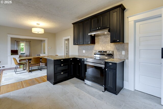 8113 SE Morrison St, Portland, OR 97215 - kitchen featuring electric stove, under cabinet range hood, backsplash, light stone countertops, and a peninsula
