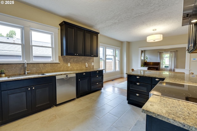 8113 SE Morrison St, Portland, OR 97215 - kitchen featuring dishwasher, a sink, decorative backsplash, decorative light fixtures, and a textured ceiling