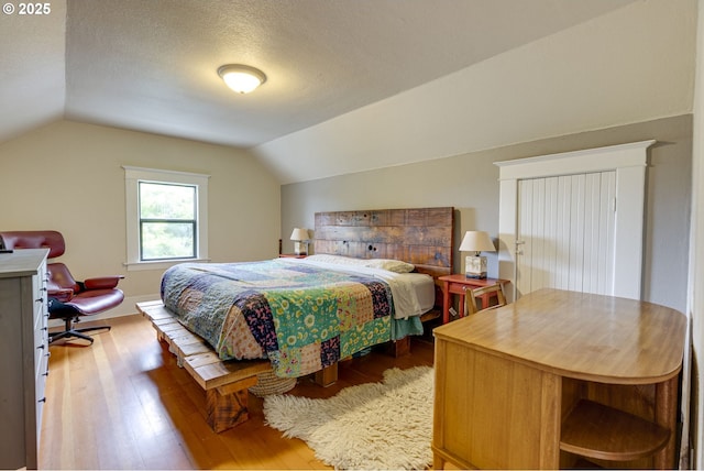8113 SE Morrison St, Portland, OR 97215 - bedroom featuring wood finished floors, vaulted ceiling, and a textured ceiling