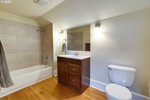 8113 SE Morrison St, Portland, OR 97215 - bathroom with wood finished floors, bathing tub / shower combination, toilet, vanity, and baseboards