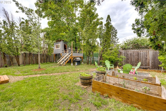 8113 SE Morrison St, Portland, OR 97215 - view of yard with a vegetable garden, stairs, and a deck