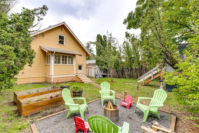 8113 SE Morrison St, Portland, OR 97215 - rear view of house featuring a fire pit and a garden