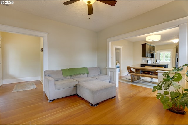 8113 SE Morrison St, Portland, OR 97215 - living area with light wood-style floors, ceiling fan, and baseboards