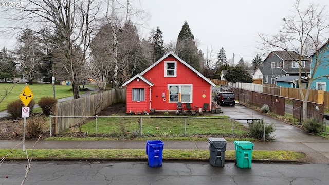 view of front facade with fence private yard and a front yard