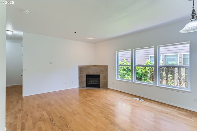 2482 25th Ave, Forest Grove, OR 97116 - unfurnished living room with light wood-style flooring and a tile fireplace