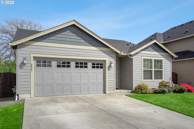 ranch-style home with a front lawn, fence, roof with shingles, an attached garage, and driveway