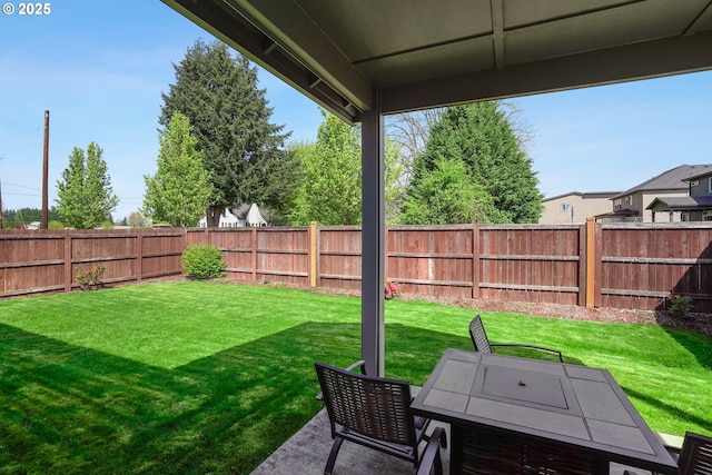 view of yard featuring a patio, a fenced backyard, and outdoor dining space
