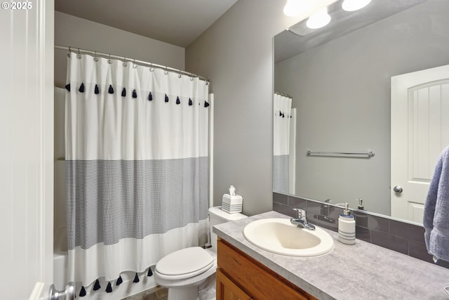 bathroom featuring vanity, toilet, and shower / tub combo