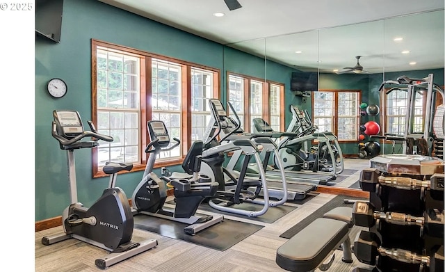 exercise room with ceiling fan and carpet flooring