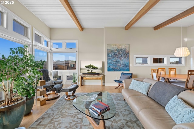 living room featuring beam ceiling and light wood-type flooring