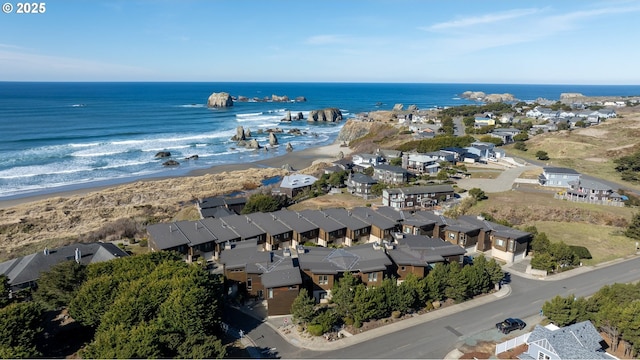 drone / aerial view featuring a water view and a beach view