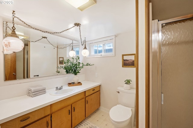 bathroom with toilet, a stall shower, and vanity