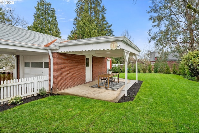 view of yard featuring a garage, a patio, and fence