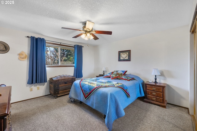 bedroom featuring ceiling fan, light carpet, and a textured ceiling