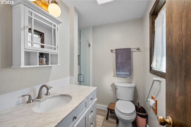 bathroom featuring vanity, an enclosed shower, wood-type flooring, and toilet