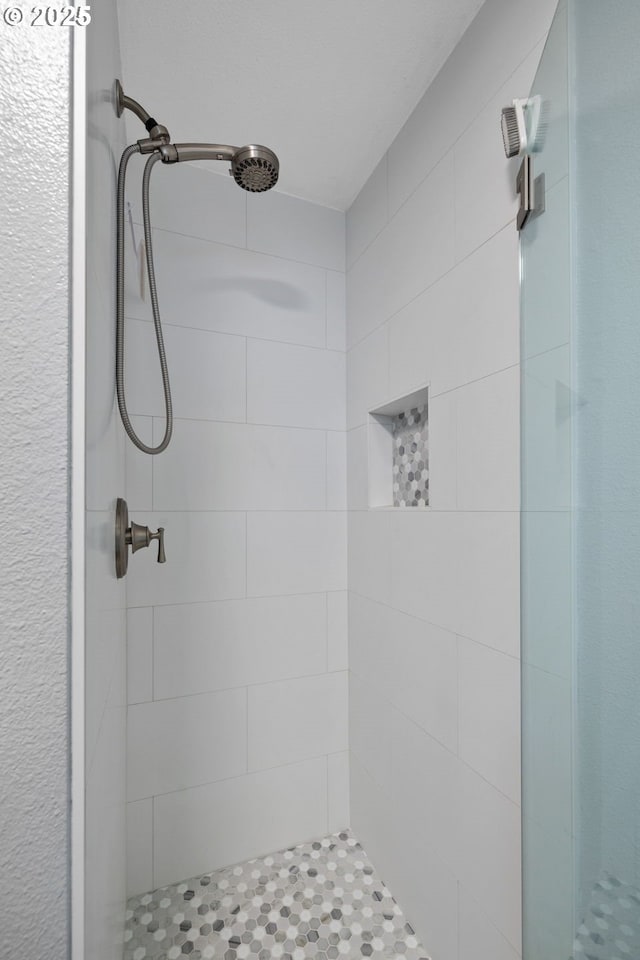 bathroom with tiled shower